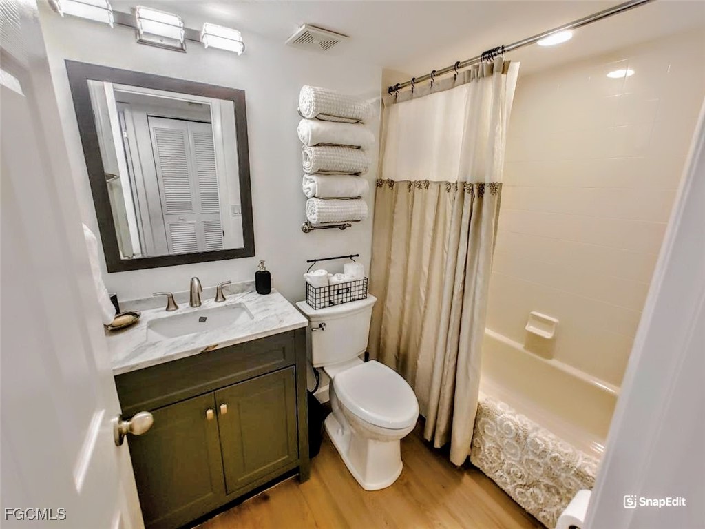 5830 Trailwinds Drive, Unit 813 Fort Myers, FL 33907 - Photo 23 of 39 a bathroom with a sink a toilet a mirror and shower