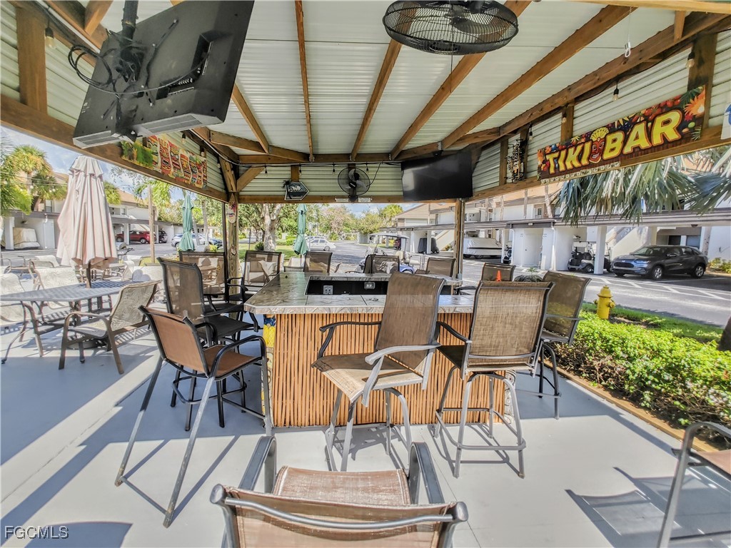 5830 Trailwinds Drive, Unit 813 Fort Myers, FL 33907 - Photo 28 of 39 a view of a chairs and table in a patio