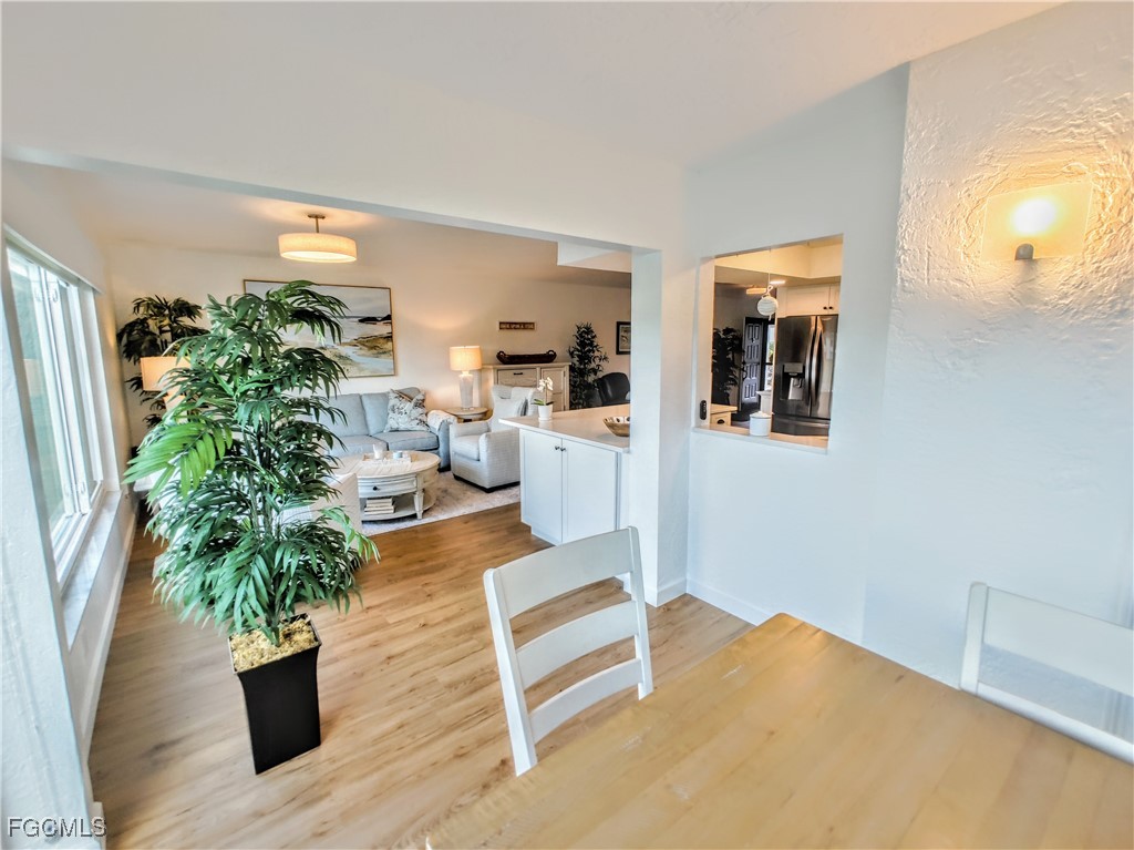 5830 Trailwinds Drive, Unit 813 Fort Myers, FL 33907 - Photo 4 of 39 a living room with furniture and a potted plant