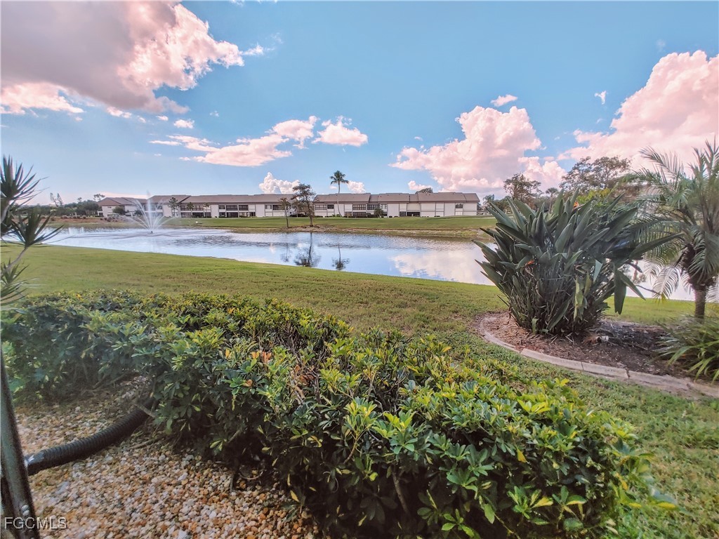 5830 Trailwinds Drive, Unit 813 Fort Myers, FL 33907 - Photo 9 of 39 a view of a lake with houses