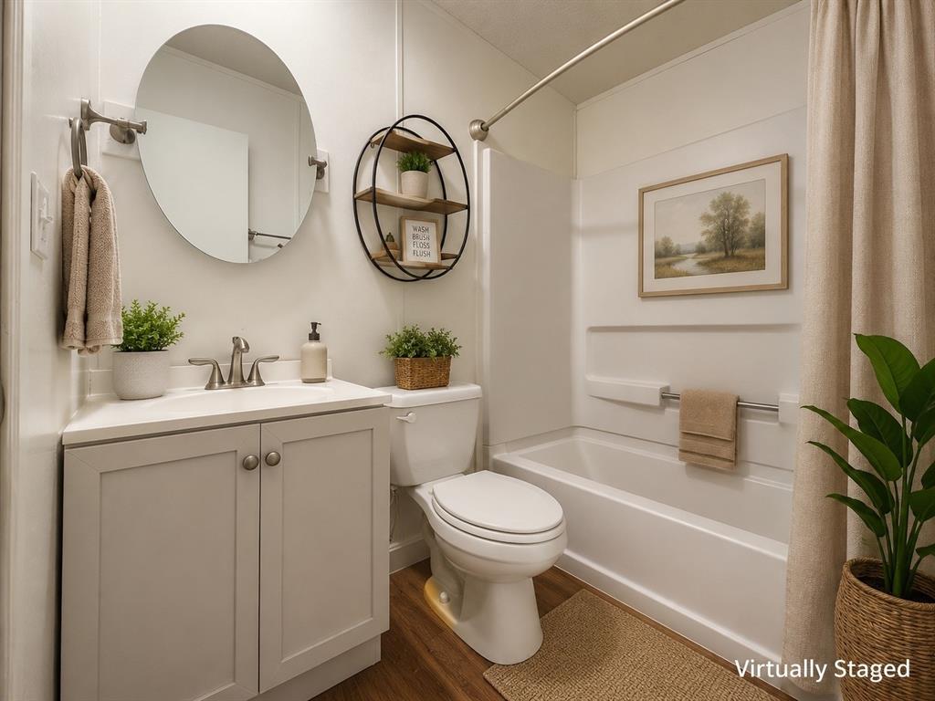 18327 Gholson Road Waco, TX 76705 - Photo 13 of 19 White vanity with a neutral countertop, undermount sink, and brushed nickel faucet