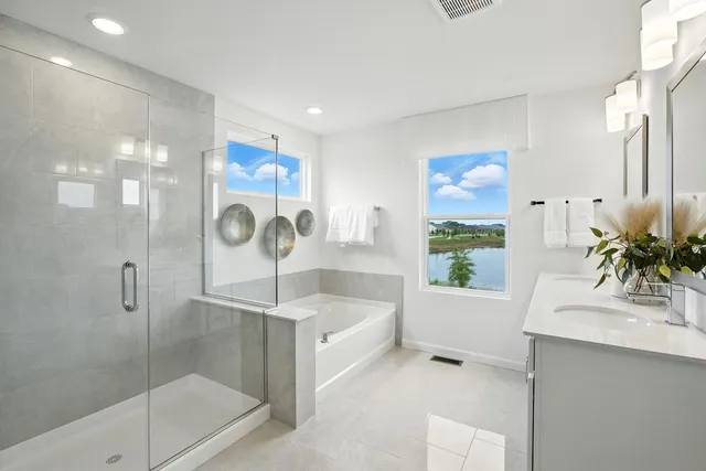 a bathroom with a bathtub shower sink and mirror