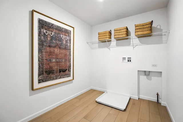 a view of a room with wooden floor and a ceiling fan