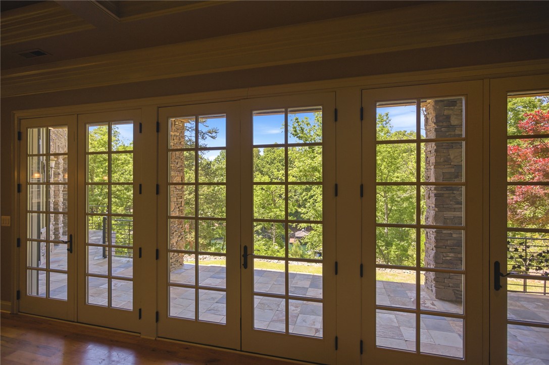 130 River Ridge Road Sunset, SC 29685 - Photo 35 of 47 These French doors open to an inviting patio, offering a serene view of mature trees and distant landscape.