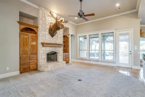 a view of a livingroom with an empty space and a fireplace