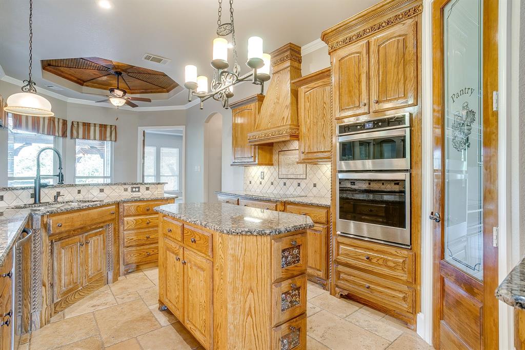 9549 Dickson Road Fort Worth, TX 76179 - Photo 19 of 40 a spacious bathroom with a granite countertop sink a mirror a bathtub and shower