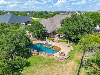an aerial view of a house with outdoor space and lake view