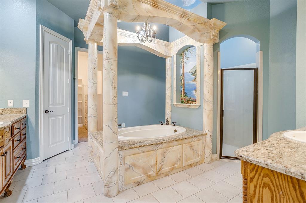 9549 Dickson Road Fort Worth, TX 76179 - Photo 23 of 40 a spacious bathroom with a sink a mirror and a bathtub