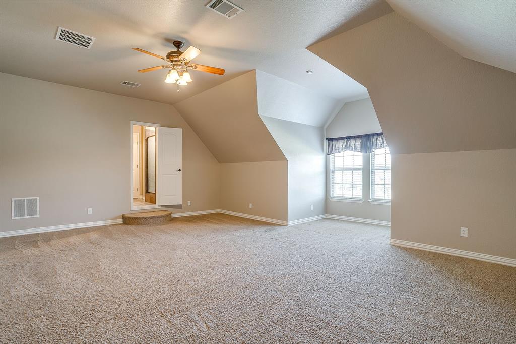 9549 Dickson Road Fort Worth, TX 76179 - Photo 28 of 40 an empty room with windows and chandelier fan