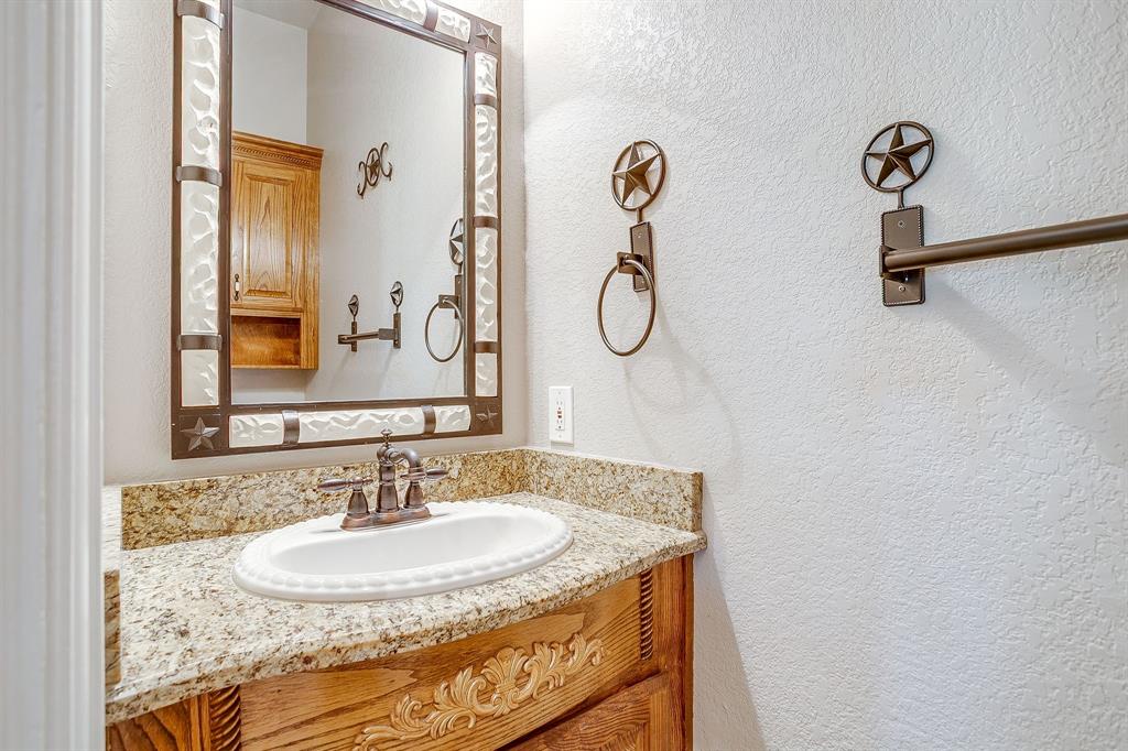 9549 Dickson Road Fort Worth, TX 76179 - Photo 30 of 40 a bathroom with a sink and a mirror