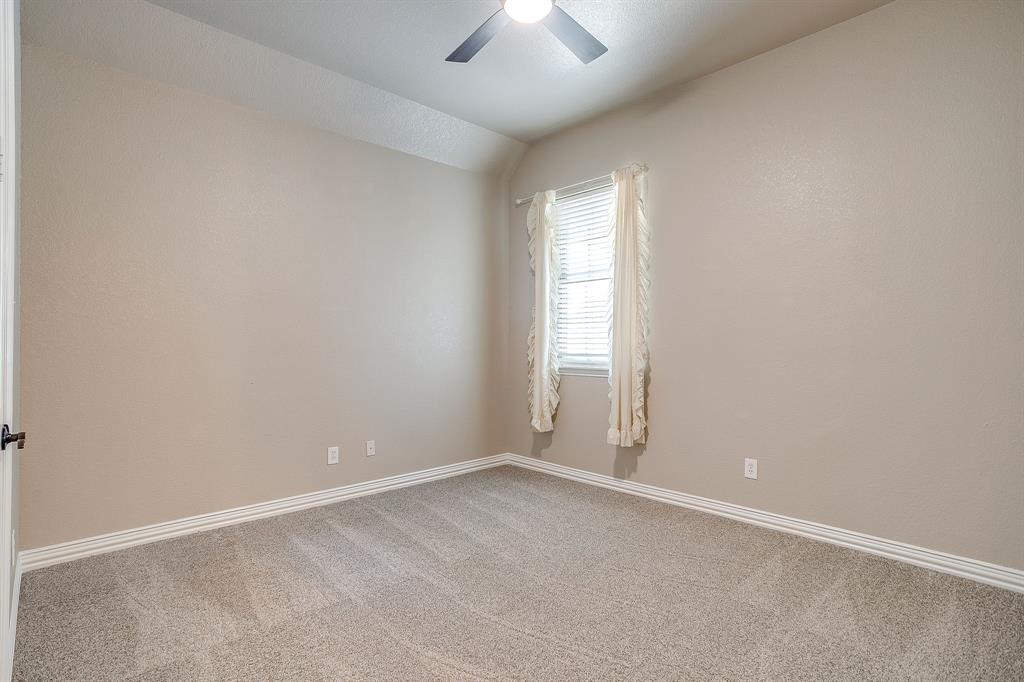 9549 Dickson Road Fort Worth, TX 76179 - Photo 31 of 40 an empty room with a window and a ceiling fan