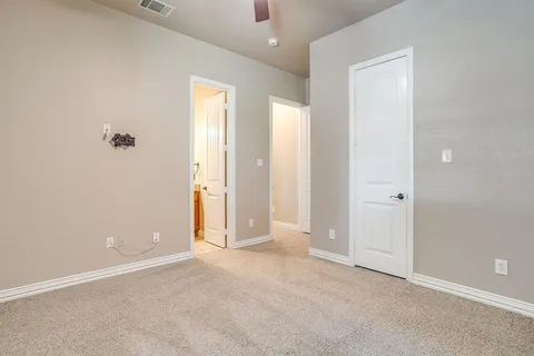 an empty room with closet and a bathroom view
