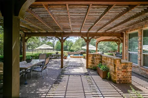 a view of a patio with a dining table and chairs