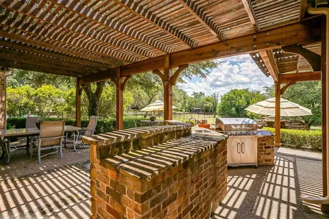 a view of a patio with table and chairs and wooden floor