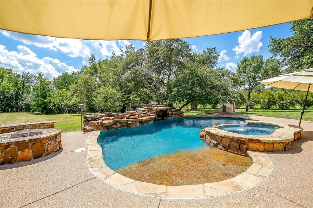 9549 Dickson Road Fort Worth, TX 76179 - Photo 35 of 40 a view of a swimming pool with an outdoor space and seating area