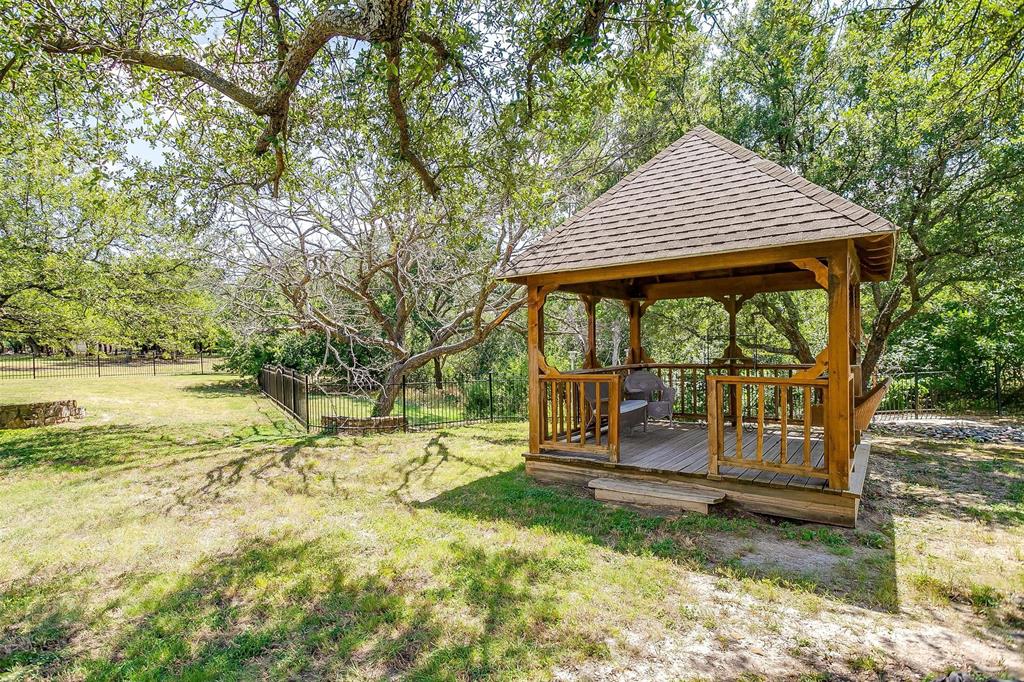 9549 Dickson Road Fort Worth, TX 76179 - Photo 39 of 40 a backyard of a house with wooden floor and outdoor seating