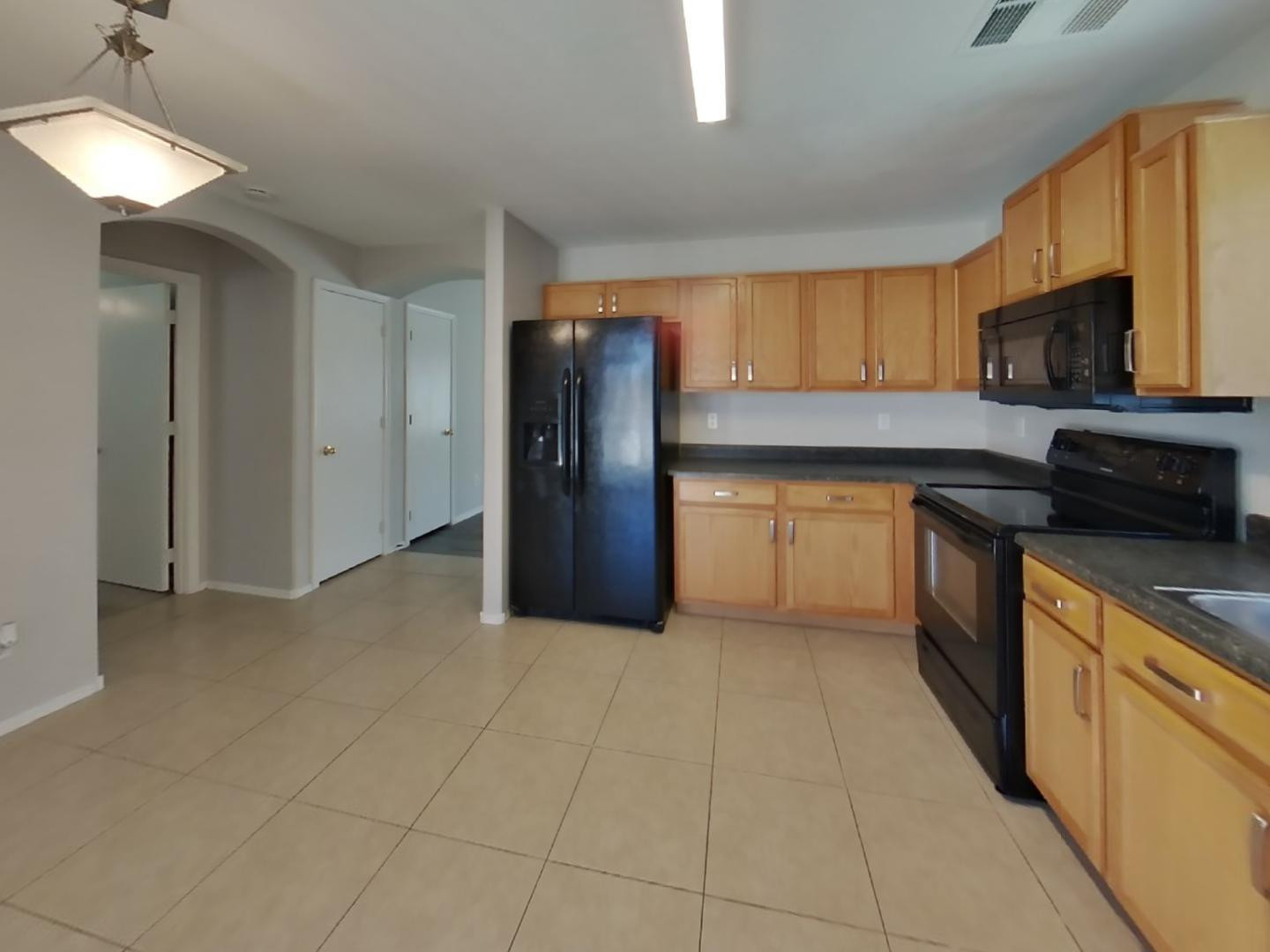 3194 West Tanner Ranch Road San Tan Valley, AZ 85144 - Photo 6 of 15 a kitchen with stainless steel appliances granite countertop a refrigerator a stove top oven a sink and dishwasher