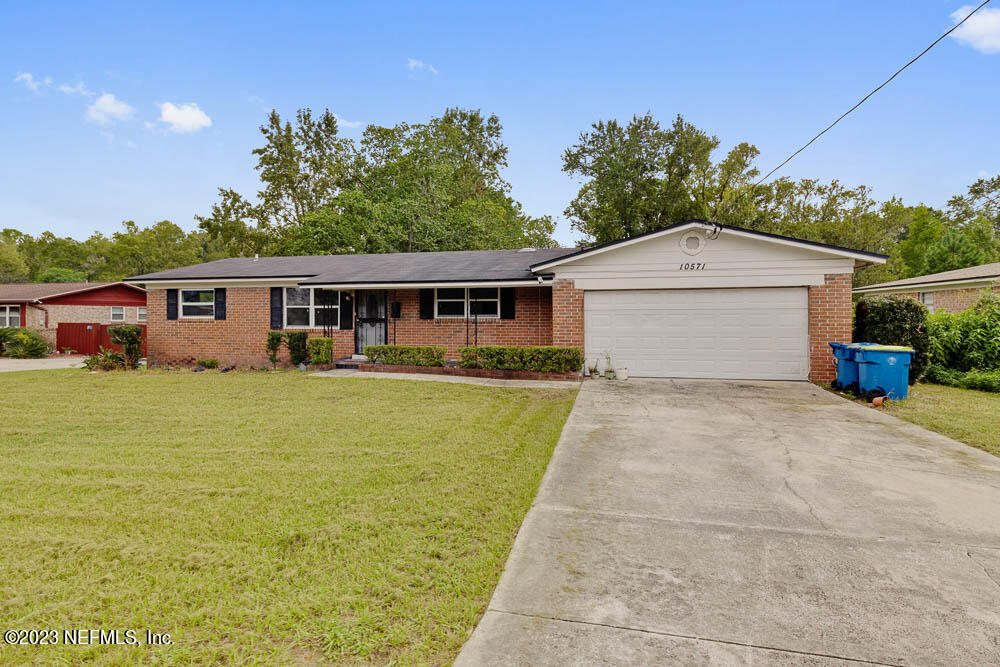 10571 Villanova Road Jacksonville, FL 32218 - Photo 1 of 21 a front view of a house with a yard