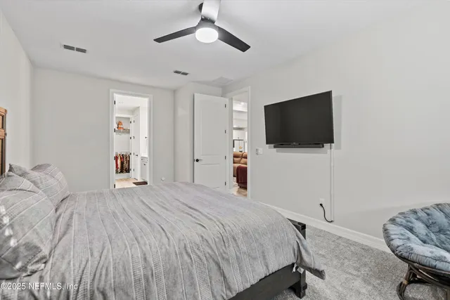 a spacious bathroom with a double vanity sink and a mirror
