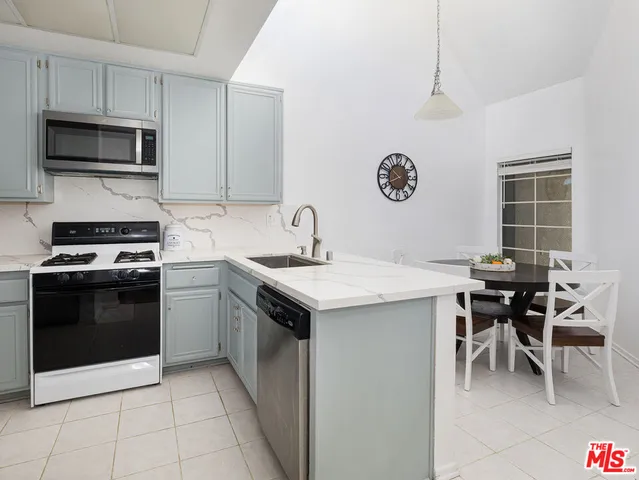 a kitchen with a sink a stove and microwave