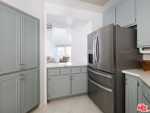 a kitchen with stainless steel appliances a refrigerator and cabinets