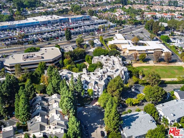 an aerial view of residential houses with city view