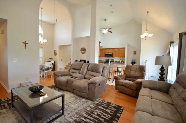 a living room with furniture a rug and a chandelier