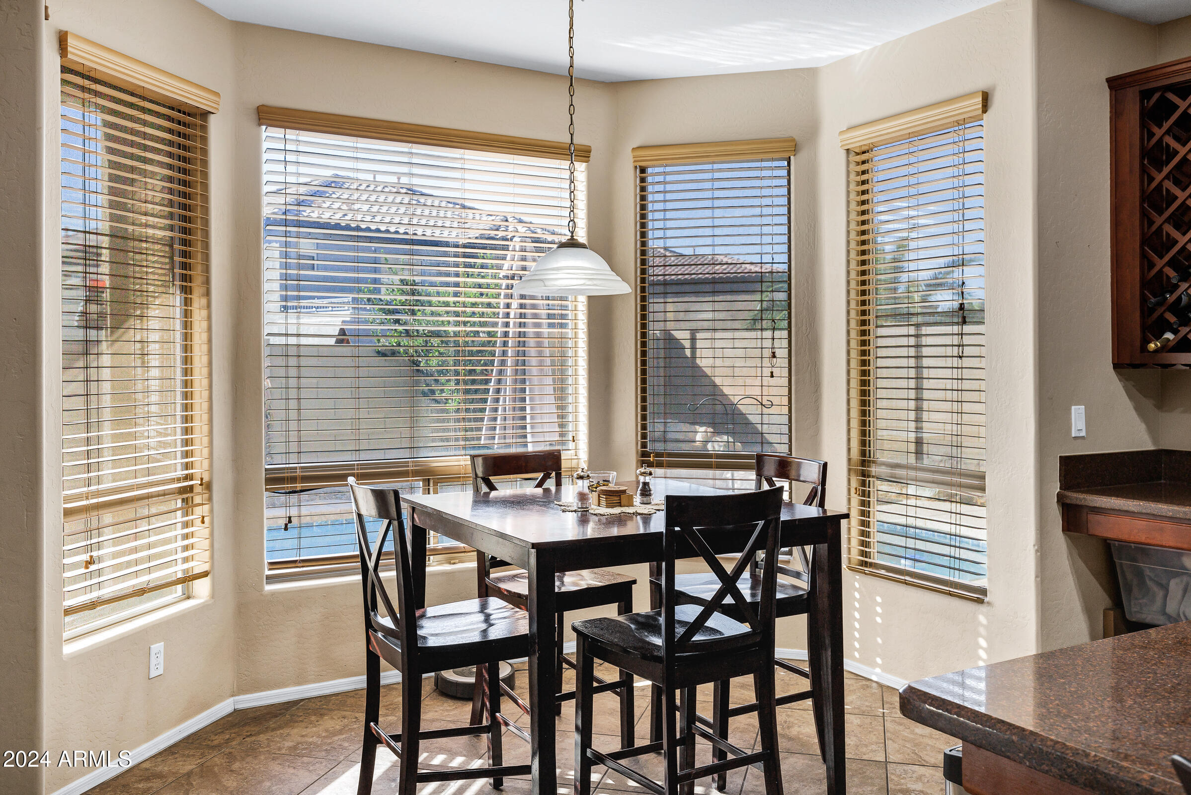 2801 West Silver Fox Way Phoenix, AZ 85045 - Photo 18 of 76 a view of a dining room with furniture and windows