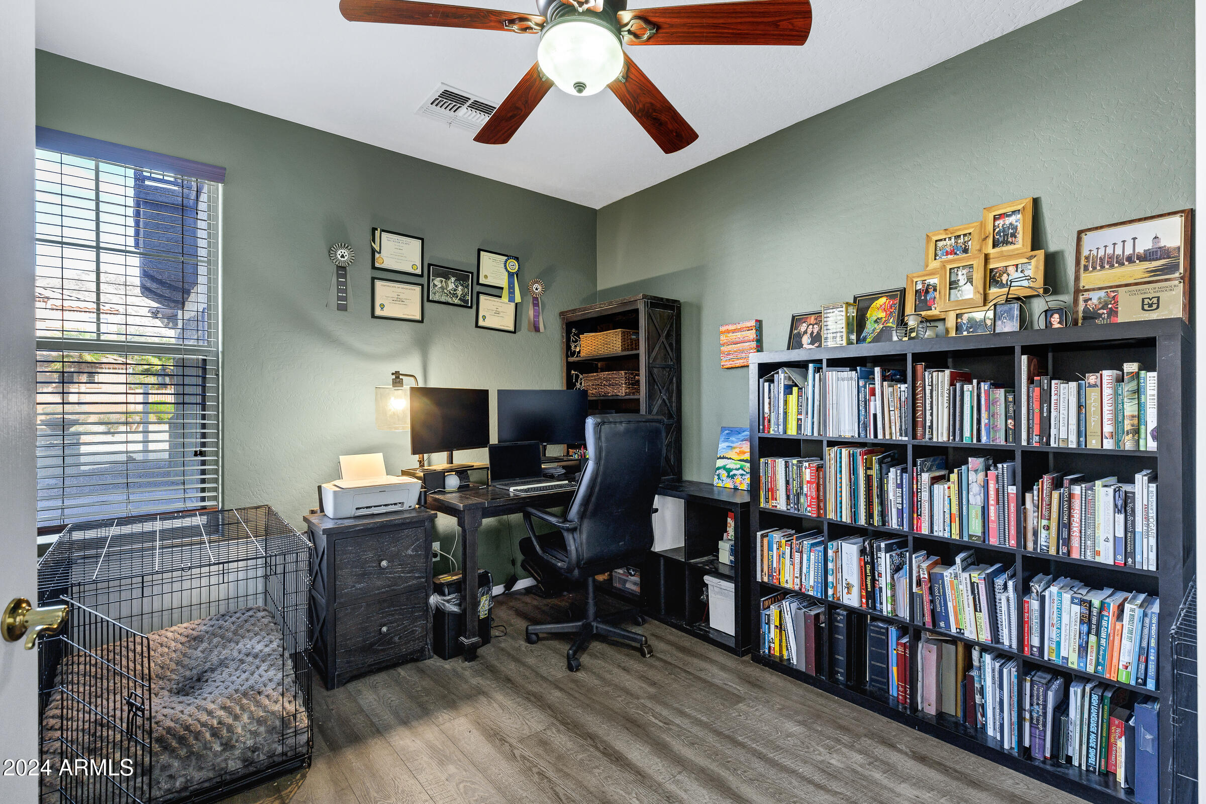 2801 West Silver Fox Way Phoenix, AZ 85045 - Photo 25 of 76 a view of a workspace with a bookshelf and a workspace