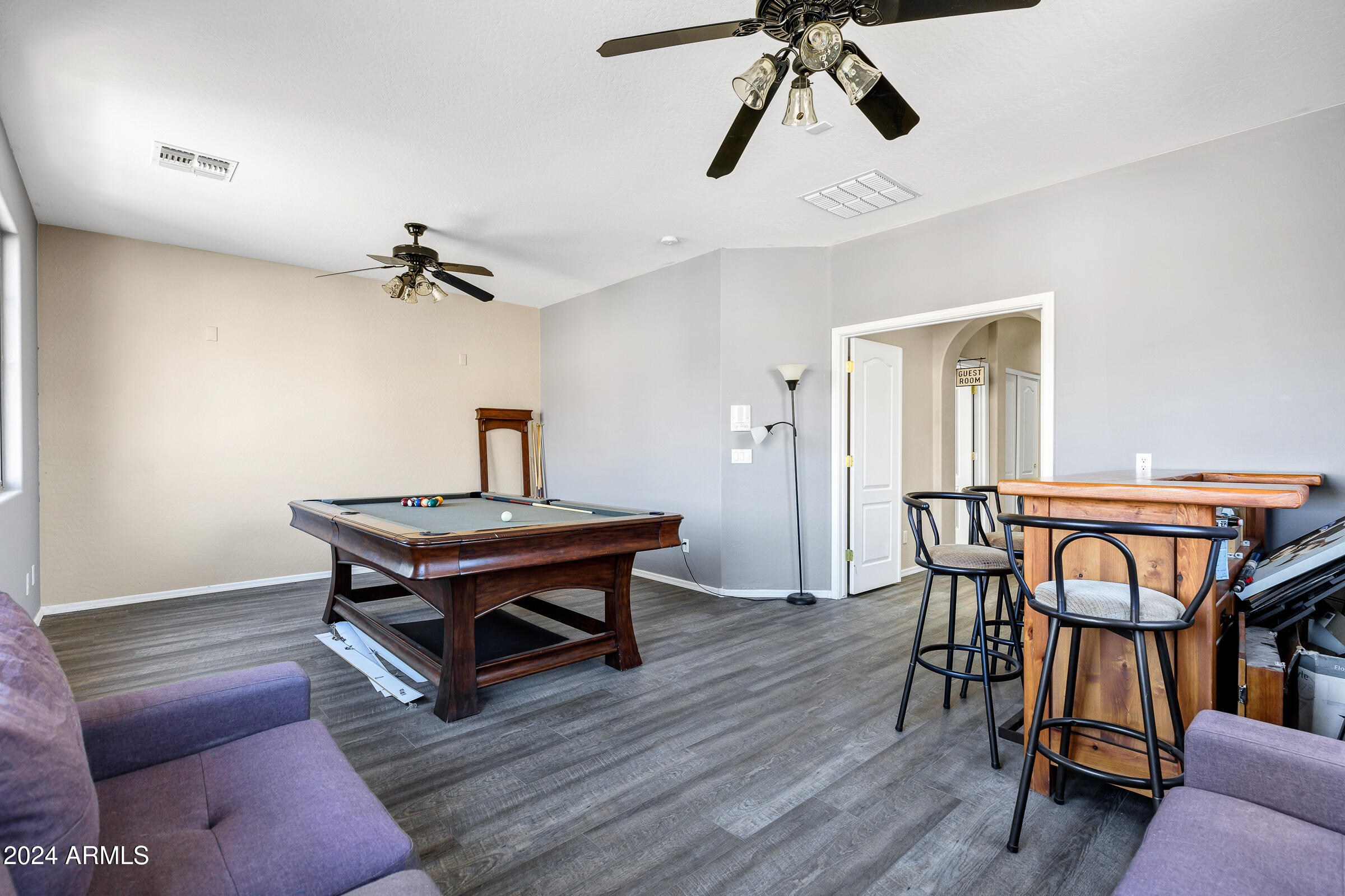 2801 West Silver Fox Way Phoenix, AZ 85045 - Photo 33 of 76 a room with a table chairs and a wooden floor