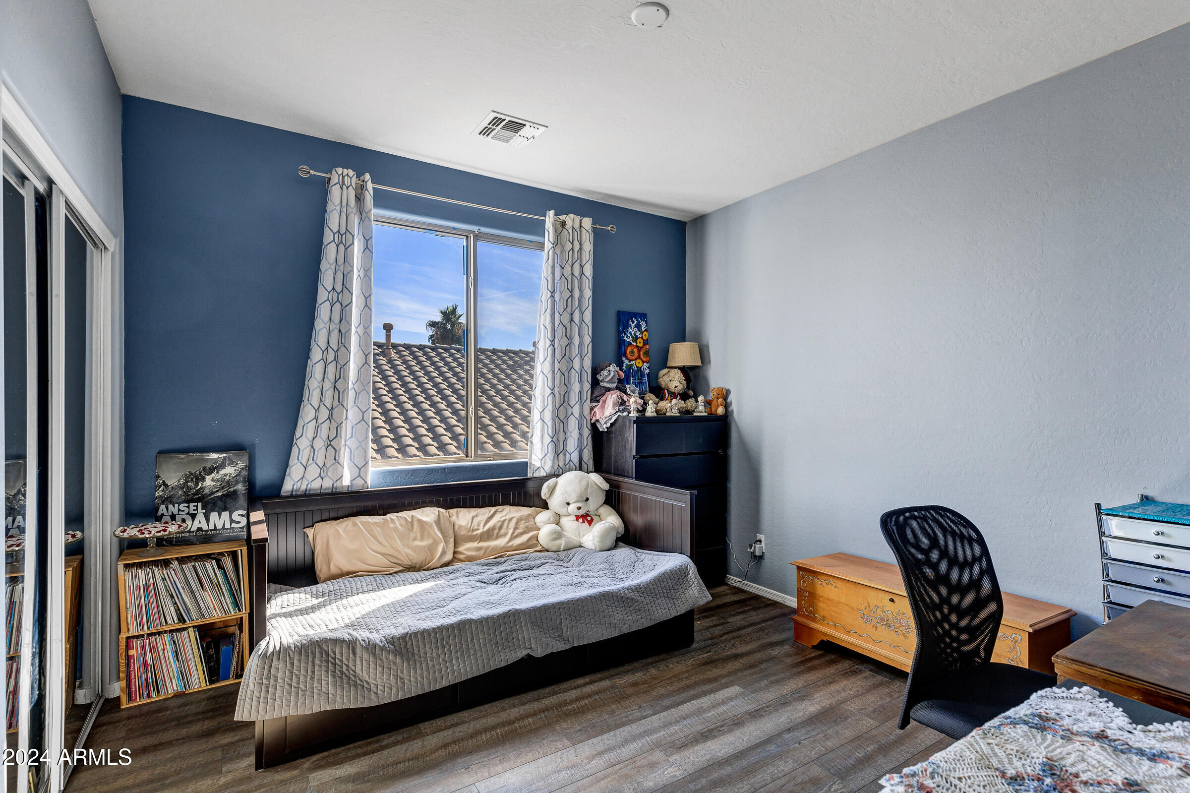 2801 West Silver Fox Way Phoenix, AZ 85045 - Photo 39 of 76 a bedroom with a bed and a chair