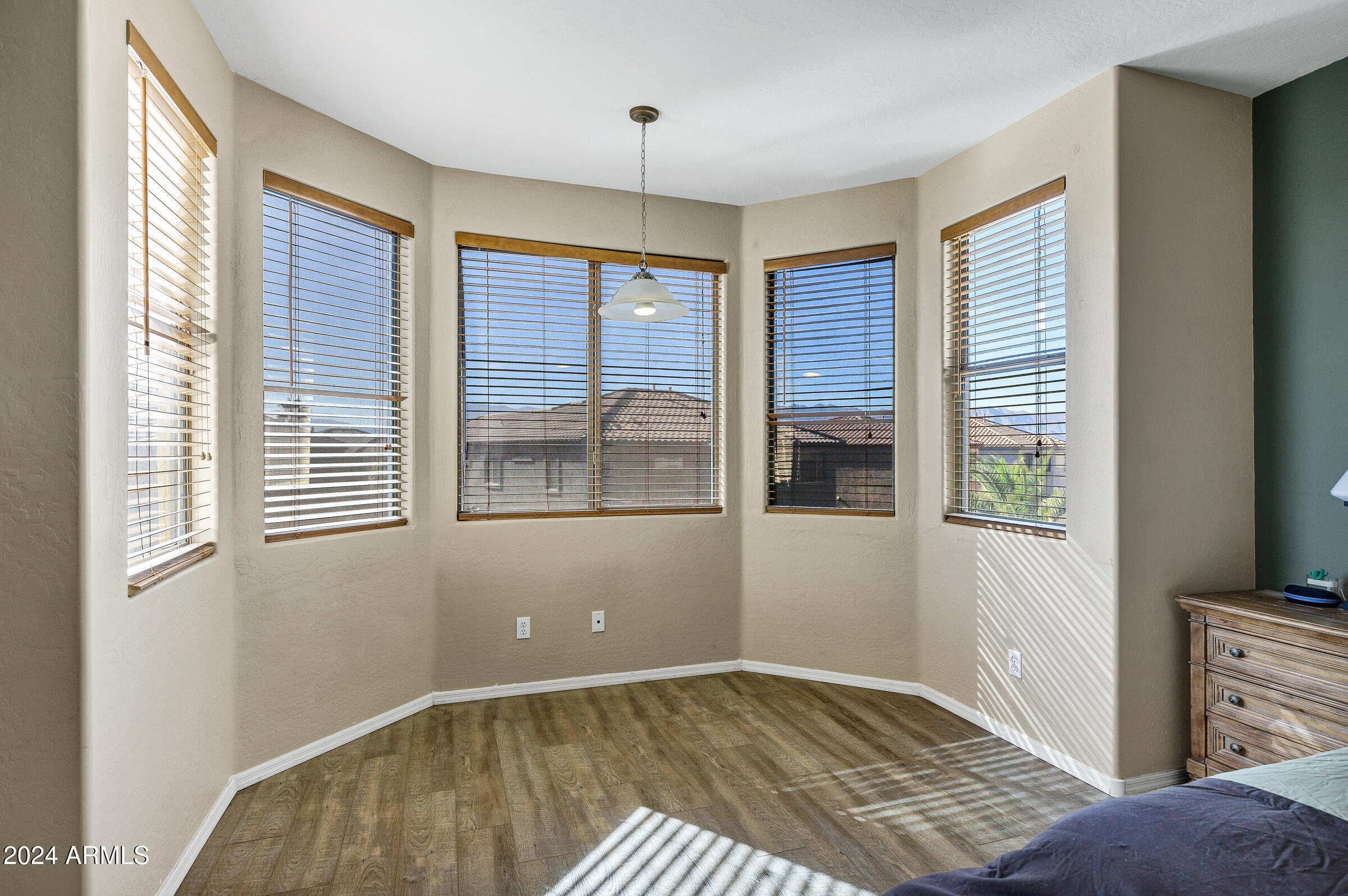 2801 West Silver Fox Way Phoenix, AZ 85045 - Photo 45 of 76 a view of an empty room with a window and wooden floor