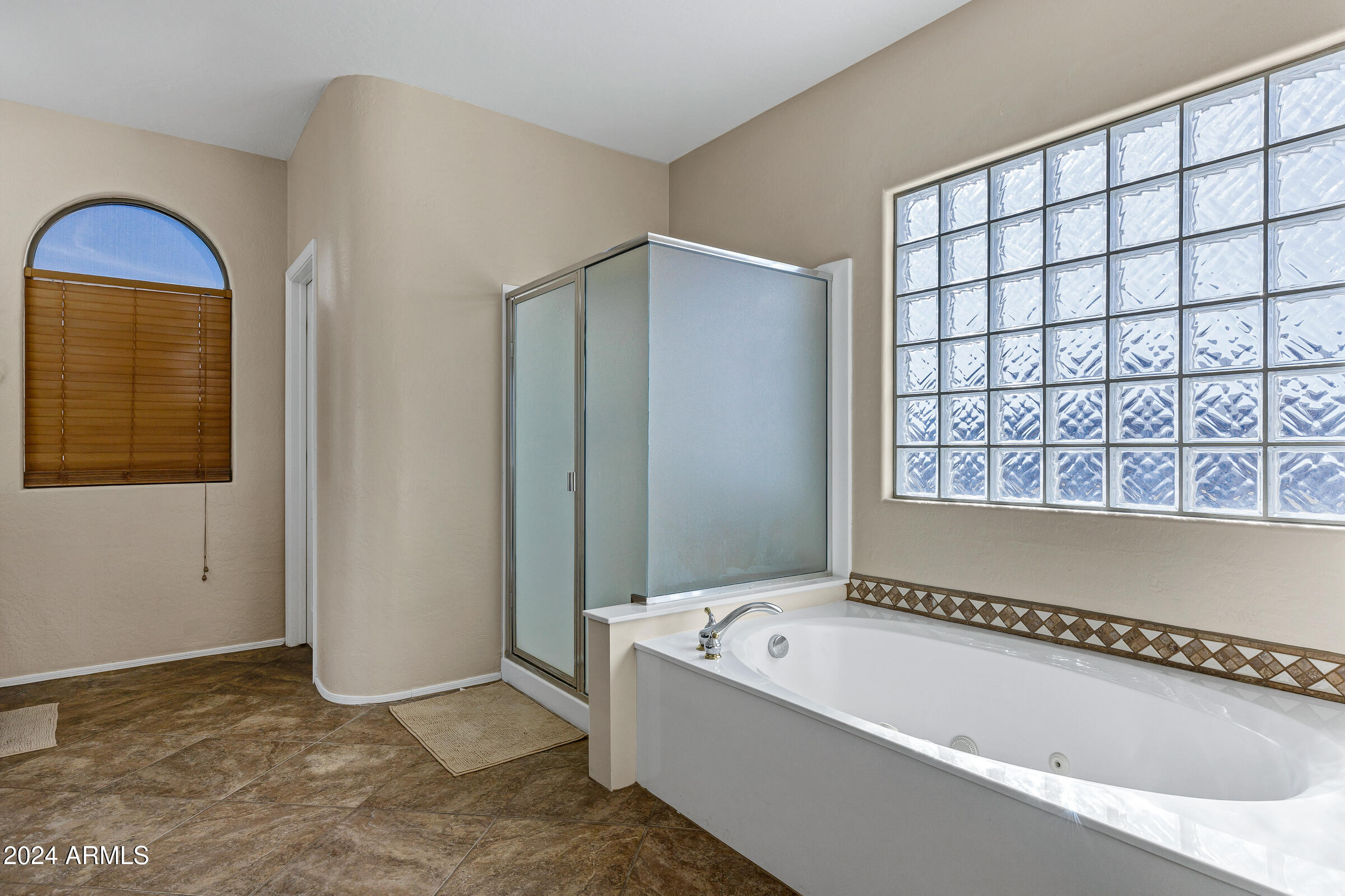 2801 West Silver Fox Way Phoenix, AZ 85045 - Photo 47 of 76 a bathroom with a bathtub and a shower