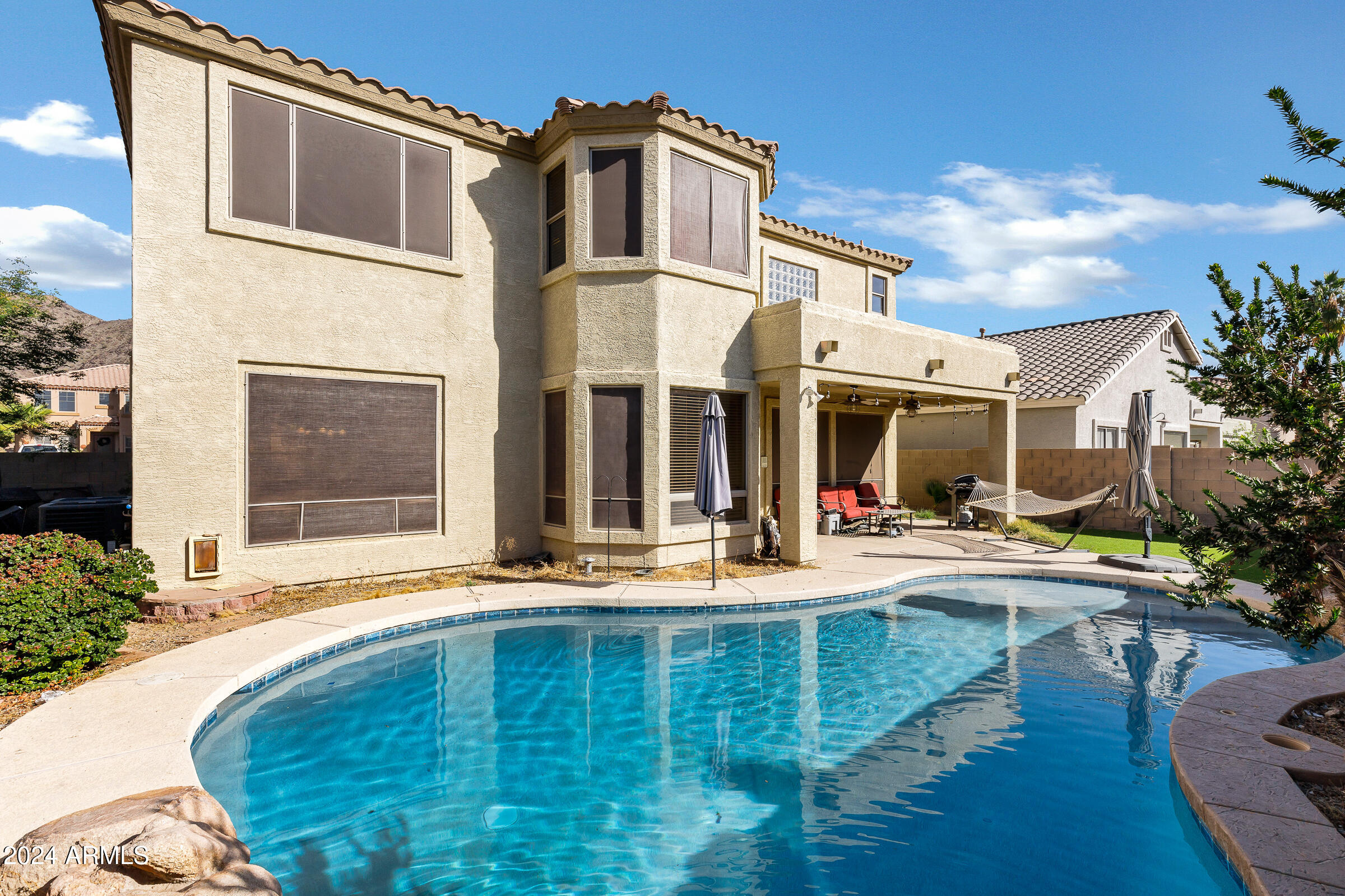2801 West Silver Fox Way Phoenix, AZ 85045 - Photo 56 of 76 a view of a white building with swimming pool in front of it