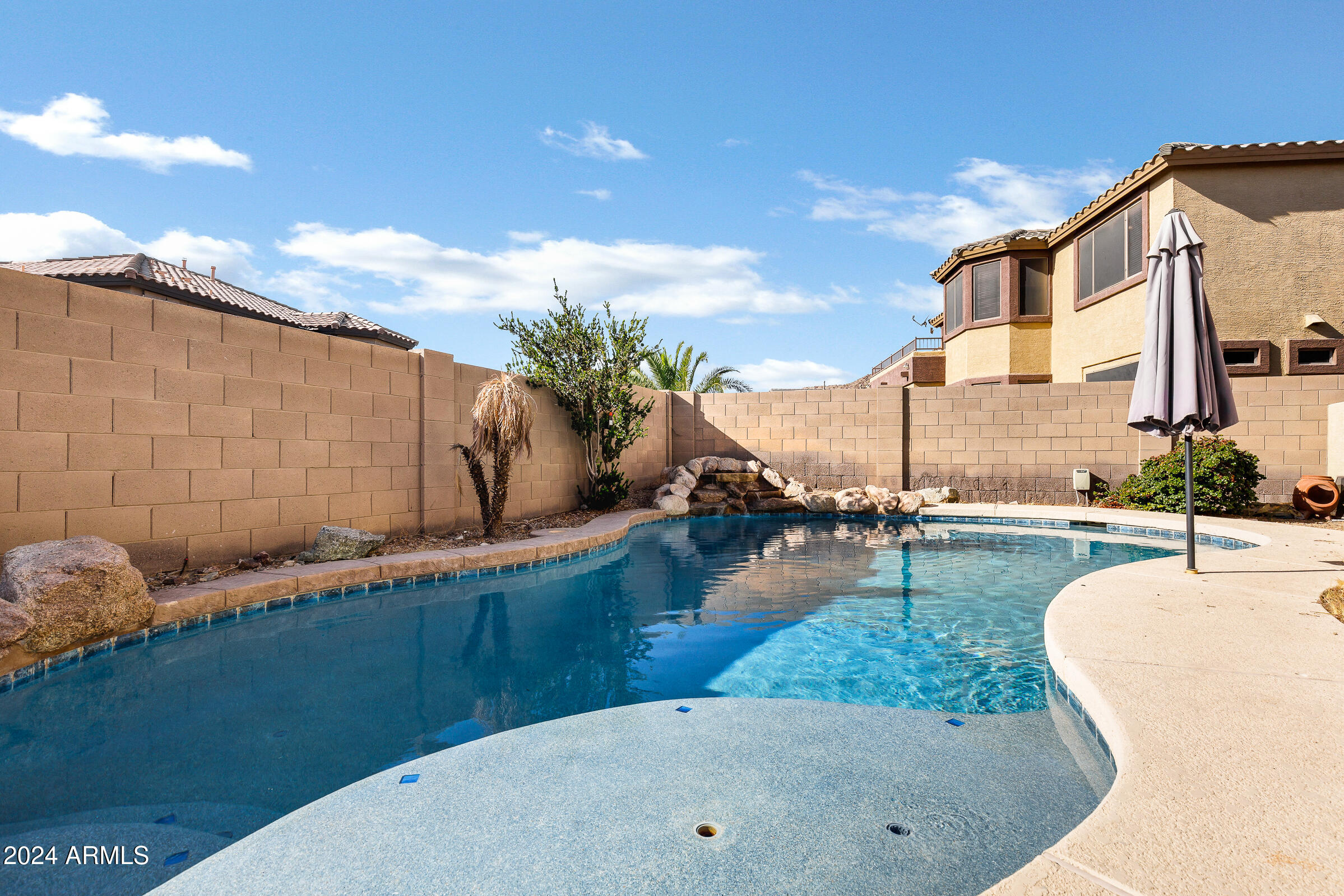 2801 West Silver Fox Way Phoenix, AZ 85045 - Photo 57 of 76 a view of a swimming pool with a lounge chair