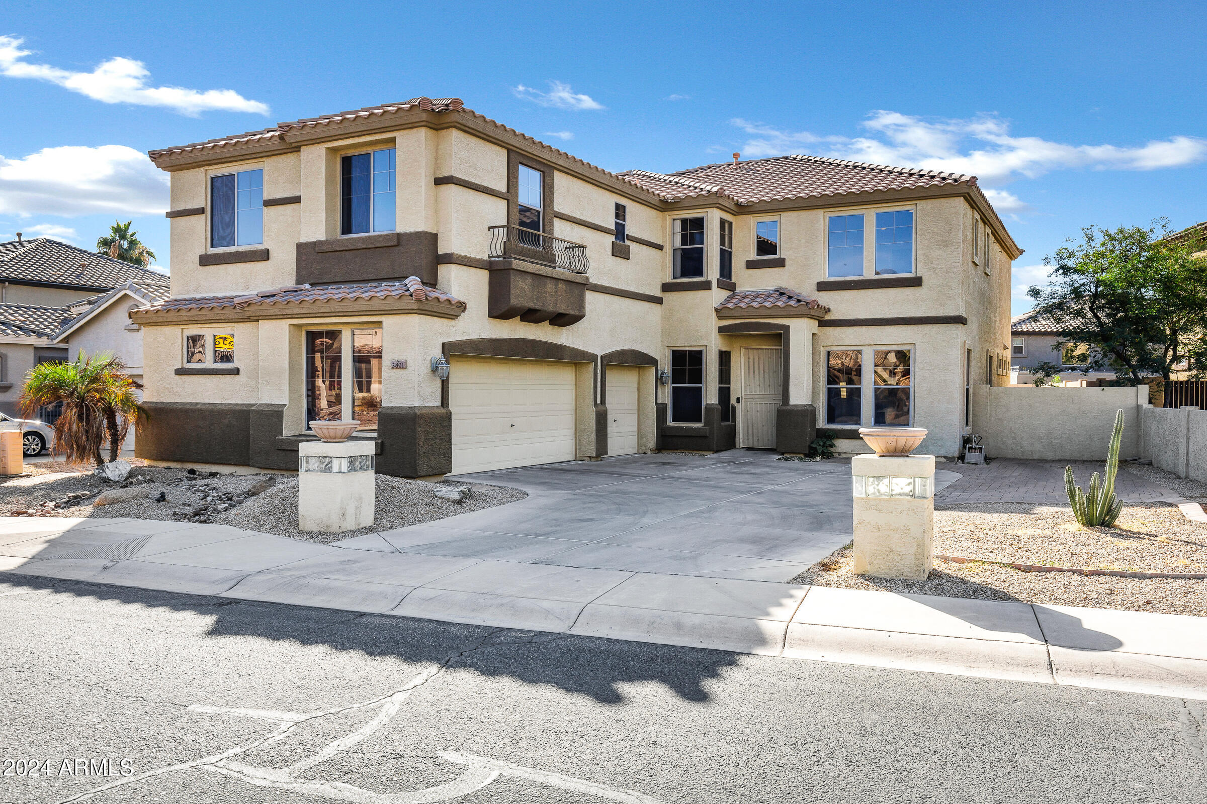 2801 West Silver Fox Way Phoenix, AZ 85045 - Photo 58 of 76 a view of a white house with large windows next to a road