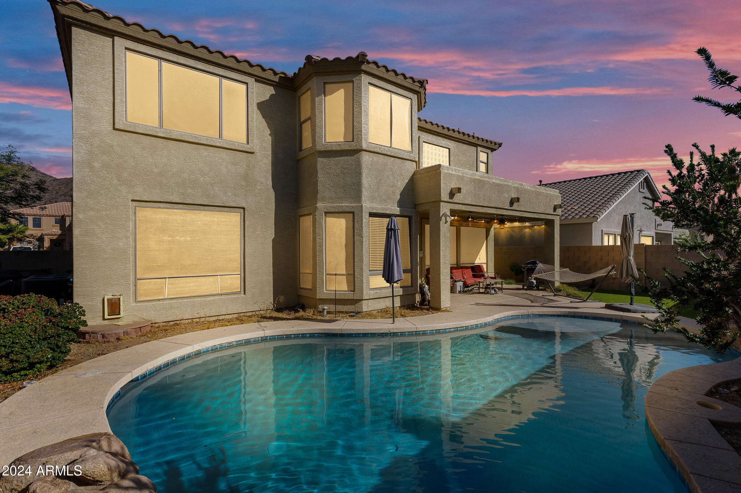 2801 West Silver Fox Way Phoenix, AZ 85045 - Photo 60 of 76 a swimming pool with outdoor seating and yard