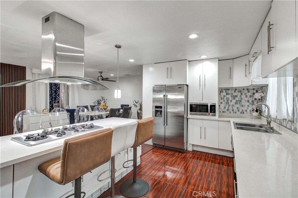 1025 South Riverside Avenue, Unit 26 Rialto, CA 92376 - Photo 14 of 27 a kitchen with stainless steel appliances kitchen island granite countertop a sink stove and refrigerator