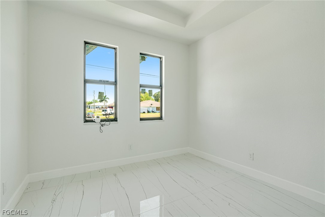 4725-4727 27th Street Southwest, Unit 4725 Lehigh Acres, FL 33973 - Photo 15 of 22 wooden floor in an empty room with a window