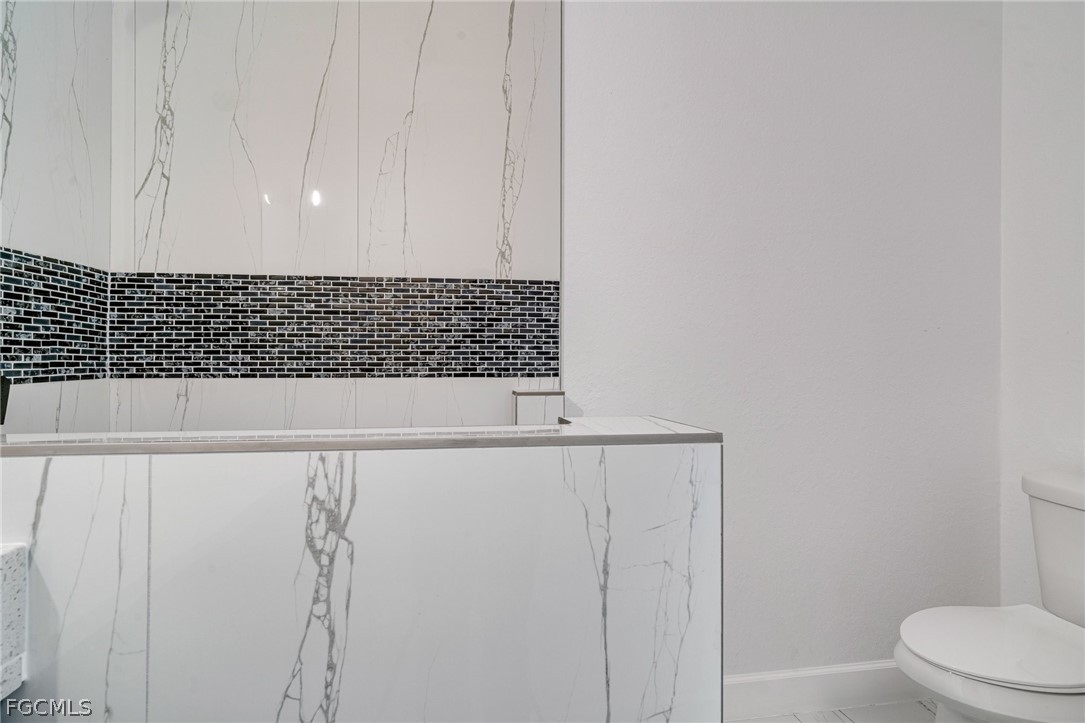 4725-4727 27th Street Southwest, Unit 4725 Lehigh Acres, FL 33973 - Photo 19 of 22 a bathroom with a bathtub and a toilet