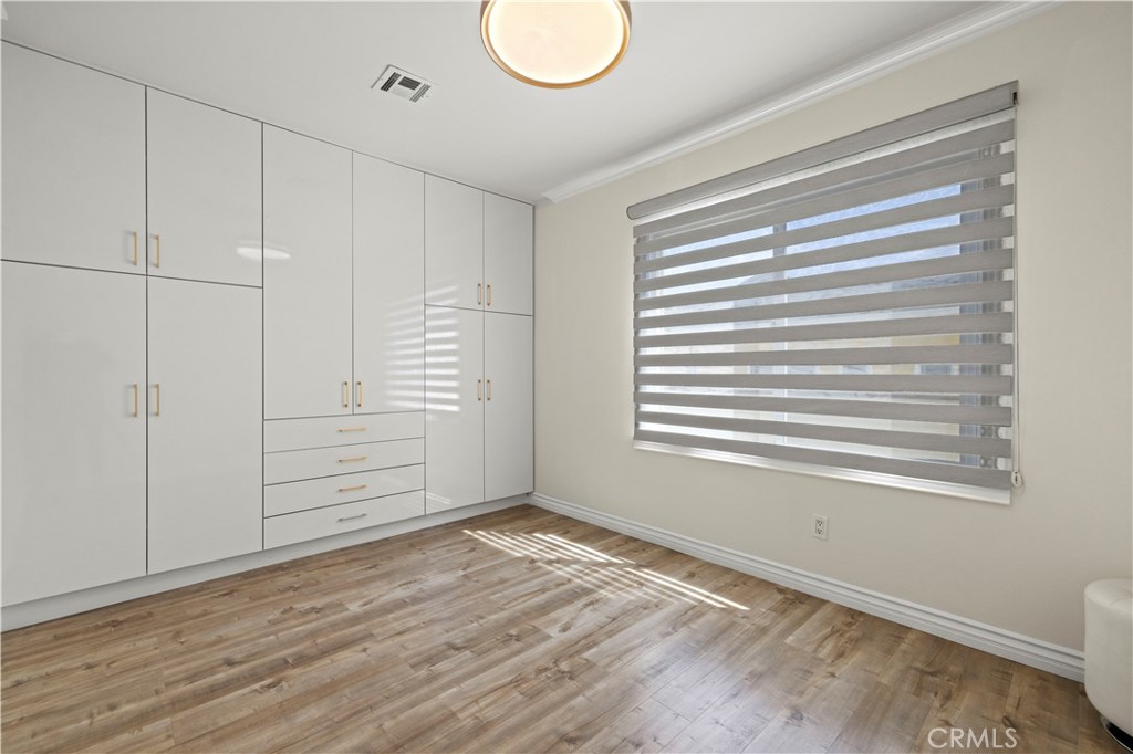 645 Glenmore Boulevard Glendale, CA 91206 - Photo 16 of 34 a view of empty room with wooden floor and fan