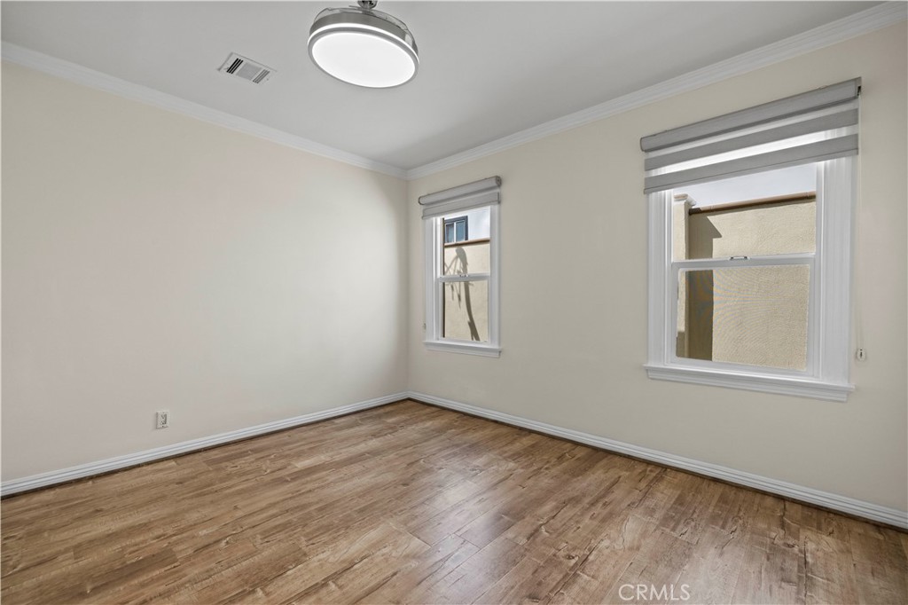 645 Glenmore Boulevard Glendale, CA 91206 - Photo 18 of 34 an empty room with wooden floor and windows