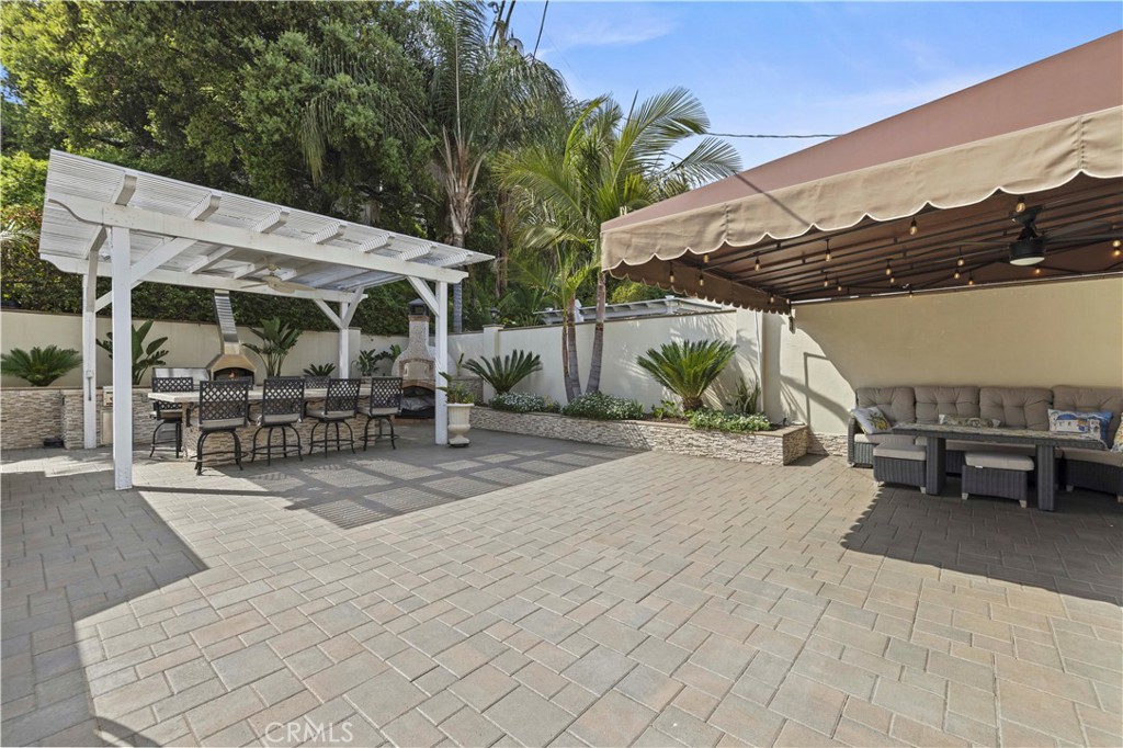 645 Glenmore Boulevard Glendale, CA 91206 - Photo 22 of 34 a view of a patio with table and chairs with wooden floor and plants