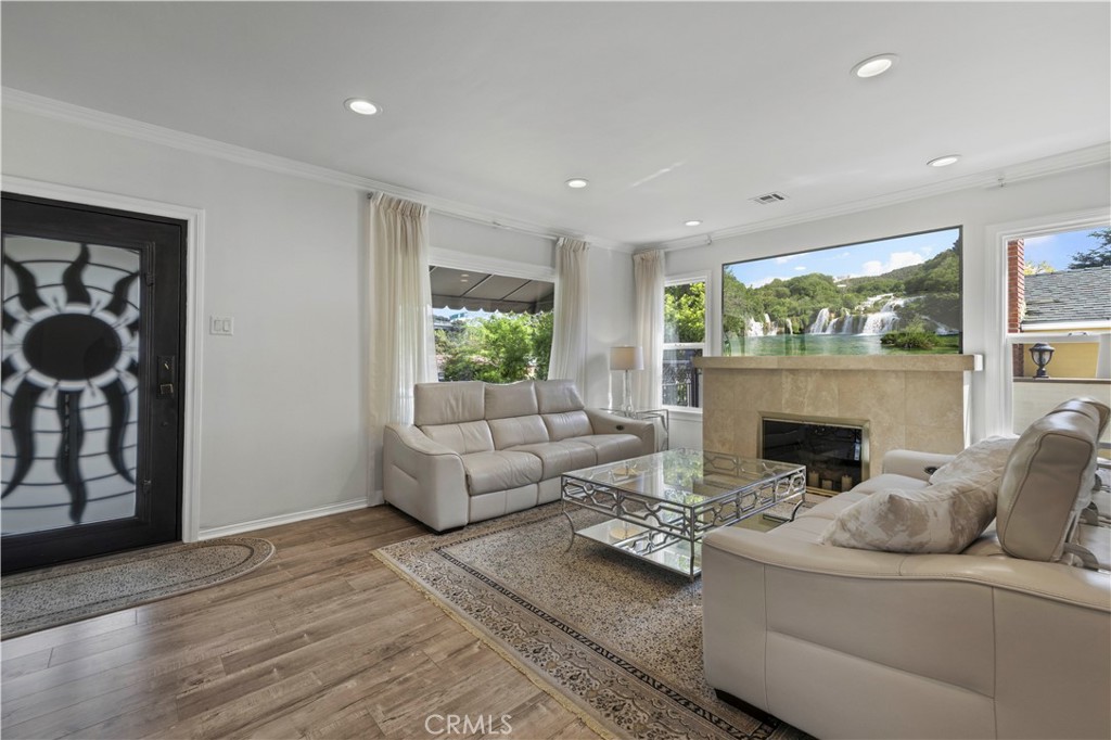645 Glenmore Boulevard Glendale, CA 91206 - Photo 4 of 34 a living room with furniture a fireplace and a large window