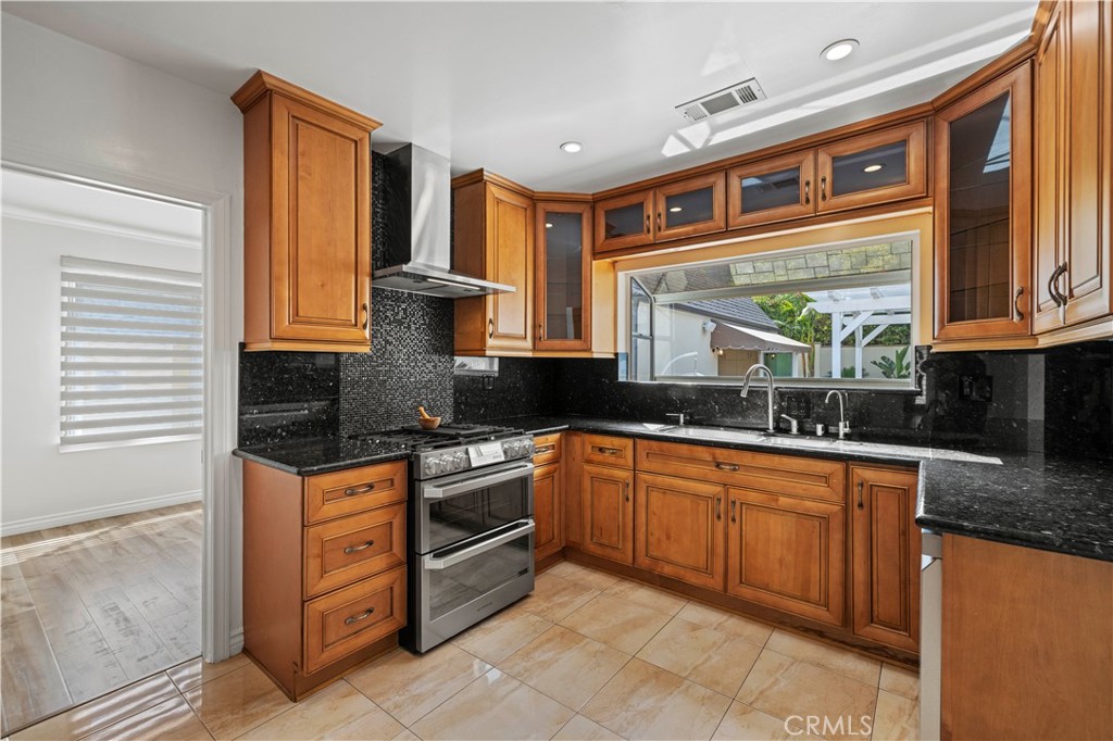 645 Glenmore Boulevard Glendale, CA 91206 - Photo 8 of 34 a kitchen with stainless steel appliances granite countertop a stove and cabinets
