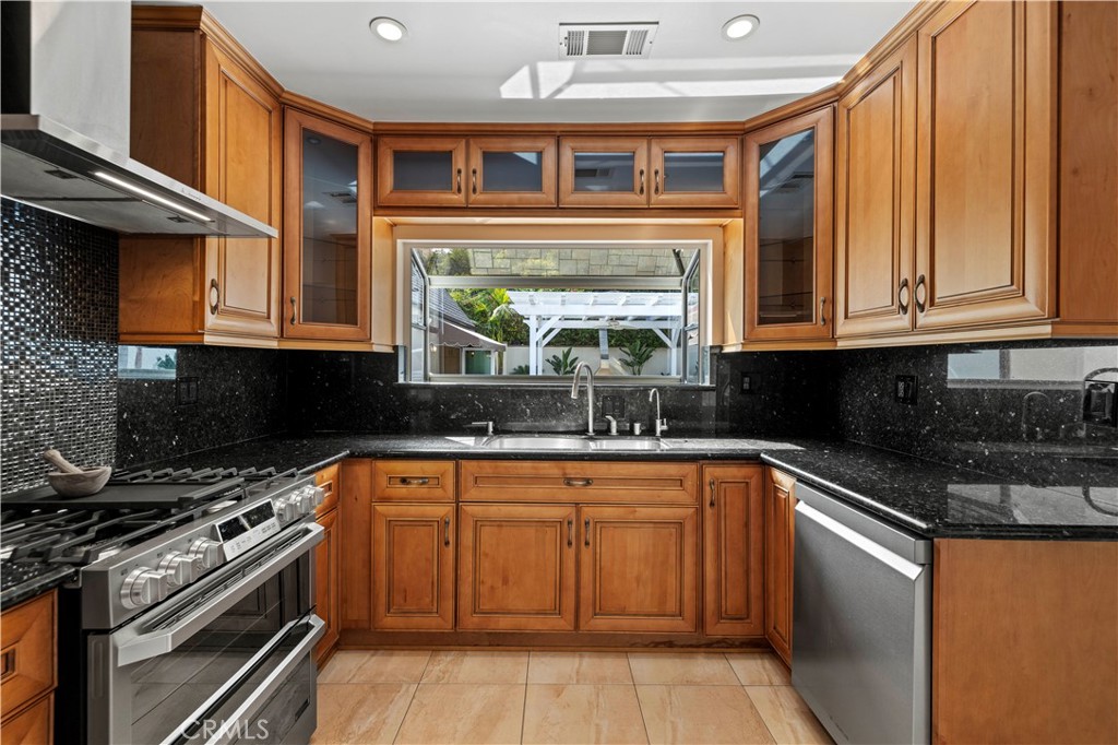 645 Glenmore Boulevard Glendale, CA 91206 - Photo 9 of 34 a kitchen with stainless steel appliances granite countertop a stove a sink and a microwave