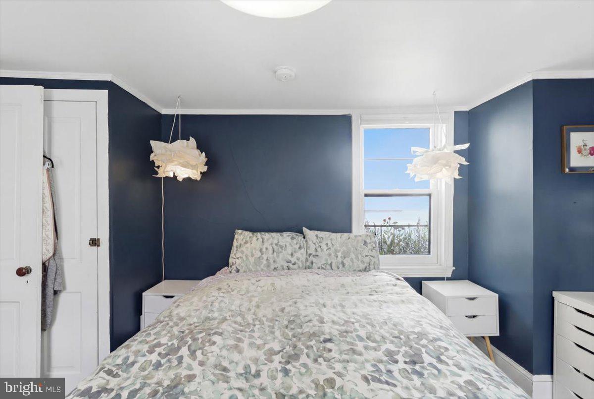 123 West 5th Street Frederick, MD 21701 - Photo 20 of 44 a bedroom with a bed and a chandelier