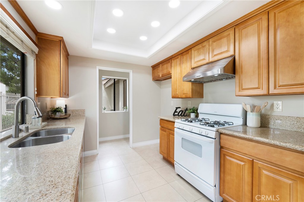242 Mountain Court Brea, CA 92821 - Photo 13 of 54 a kitchen with stainless steel appliances granite countertop a sink stove and refrigerator