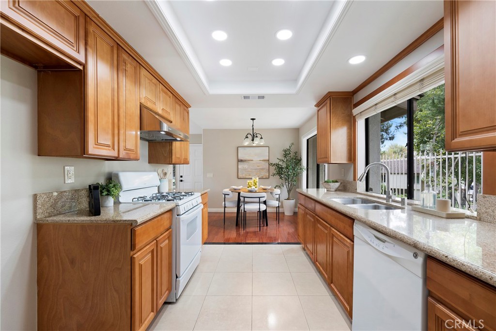 242 Mountain Court Brea, CA 92821 - Photo 16 of 54 a kitchen with counter top space a sink cabinets and appliances