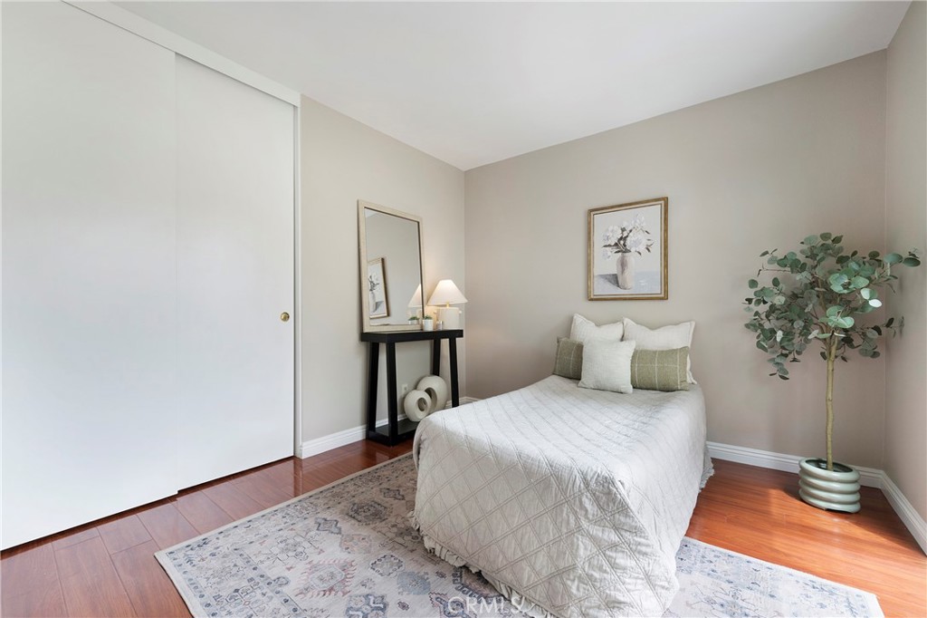 242 Mountain Court Brea, CA 92821 - Photo 31 of 54 a bedroom with a bed table and a potted plant